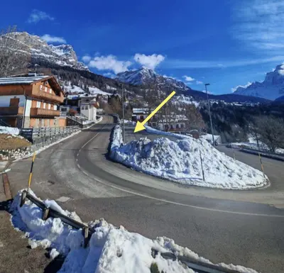 a pile of snow on the side of a road at Selva loft in Selva di Cadore