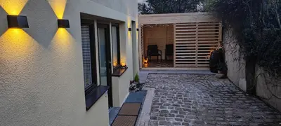 a house with a stone walkway leading to a patio at Blätterbett - letto di foglie in Bolzano