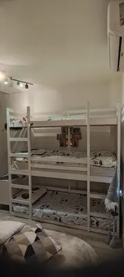 two white bunk beds in a room at Blätterbett - letto di foglie in Bolzano