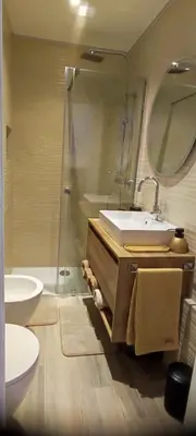 a bathroom with a sink and a toilet and a mirror at Blätterbett - letto di foglie in Bolzano