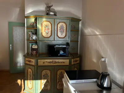 a kitchen with a cabinet with a microwave at Passo Carezza Club Apartment in Carezza al Lago