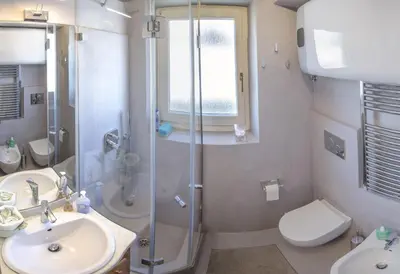 a bathroom with a shower and a sink and a toilet at Monolocale in centro a Cortina in Cortina dʼAmpezzo