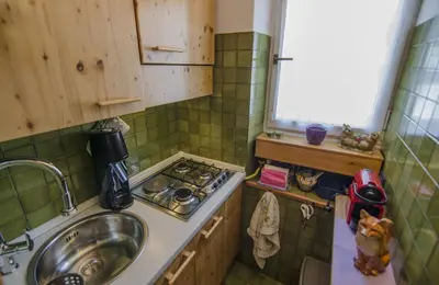 a small kitchen with a sink and a stove at Monolocale in centro a Cortina in Cortina dʼAmpezzo