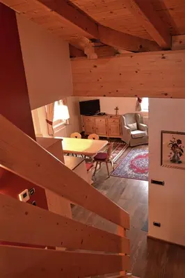 a view of a living room with a wooden ceiling at Casa Micol in Moena