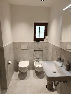 a bathroom with a toilet and a sink at Brunelle, Obertörgglerhof in Brixen