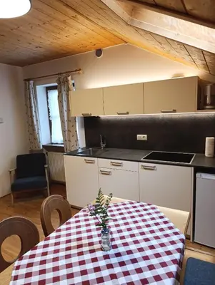 a kitchen with a table with a checkered table cloth at Brunelle, Obertörgglerhof in Brixen