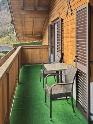 a patio with chairs and a table on a deck at Ruhige Dachwohnung mit Bergblick - Passeiertal in Saltusio