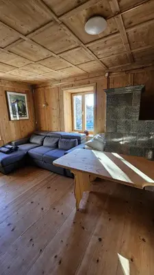 a living room with a couch and a fireplace at Majon jal Toni in Vigo di Fassa