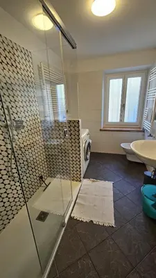 a bathroom with a shower and a toilet and a sink at Majon jal Toni in Vigo di Fassa