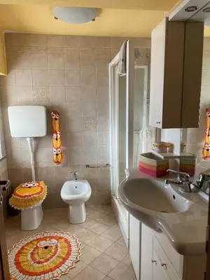 a bathroom with a sink and a toilet at Appartamento Agordo in un borgo antico in Agordo