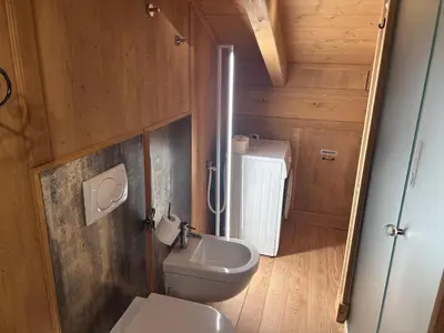 a bathroom with a toilet and a sink at Appartamento cozy tra le montagne in San Vito di Cadore