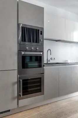 a kitchen with a stainless steel oven with a microwave at Stay COOPER l MAVIK Suite & Attic in Bolzano