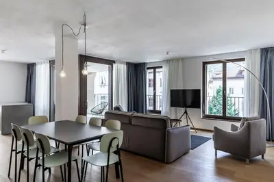 a living room with a table and a couch at Stay COOPER l MAVIK Suite & Attic in Bolzano
