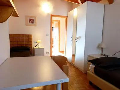 a living room with a white table and a couch at Casa Sergio in Ziano di Fiemme