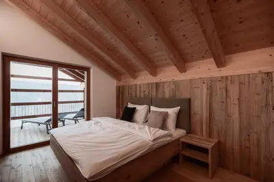 a bedroom with a bed in a room with a window at Deluxe Apartments Lantl in Falzes