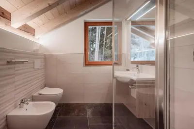 a bathroom with a toilet and a sink and a shower at Deluxe Apartments Lantl in Falzes