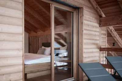 a bedroom with a bunk bed in a wooden cabin at Deluxe Apartments Lantl in Falzes