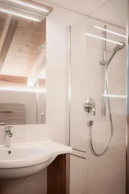 a bathroom with a sink and a shower at Deluxe Apartments Lantl in Falzes