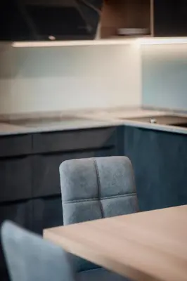 a chair in an office with a table and cabinets at Deluxe Apartments Lantl in Falzes