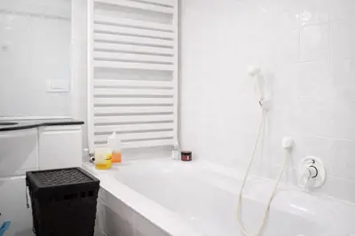 a white bathroom with a tub and a shower at Casa Dolci by Sunhome Fiemme in Tesero