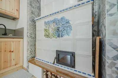 a tv on a wall in a kitchen at I Folli di Alleghe Apartment - Parking & Wi-Fi in Caprile
