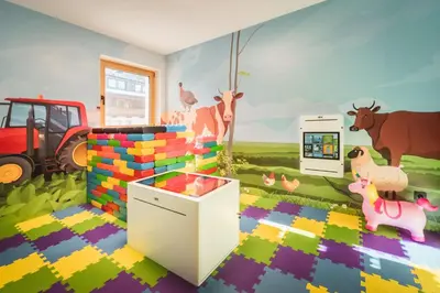 a childs room with a mural of a farm at Kuenzerhof Apartments in Braies
