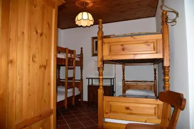 a room with two bunk beds and a hallway at Casa Via Soia in Canale dʼAgordo
