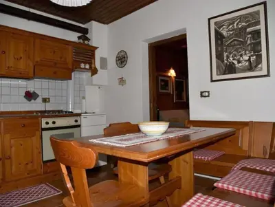 a kitchen with a wooden table with a bowl on it at Casa Via Soia in Canale dʼAgordo