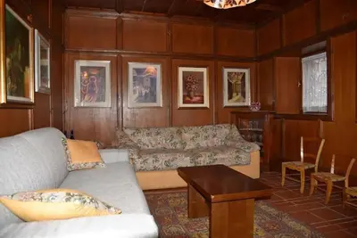 a living room with a couch and a table at Casa Via Soia in Canale dʼAgordo