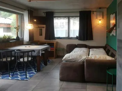 a living room with a couch and a table at Cozy Apartment At The Foot Of The Dolomites in Campitello di Fassa