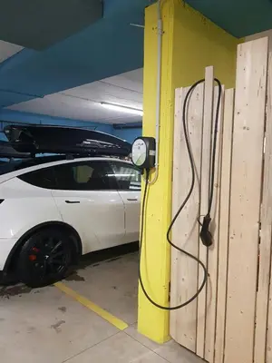 a white car is parked in a garage at Cozy Apartment At The Foot Of The Dolomites in Campitello di Fassa