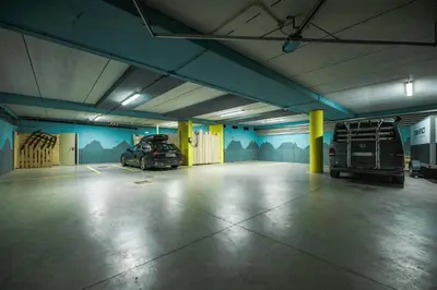 a parking garage with two cars parked in it at Cozy Apartment At The Foot Of The Dolomites in Campitello di Fassa