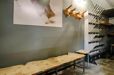 a room with a wooden table and a wall with knives at Cozy Apartment At The Foot Of The Dolomites in Campitello di Fassa