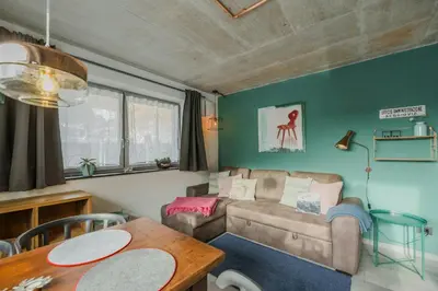 a living room with a couch and a table at Cozy Apartment At The Foot Of The Dolomites in Campitello di Fassa