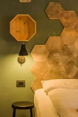 a bedroom with a bed and a wooden wall at Family-Friendly Mountain Home In The Dolomites in Campitello di Fassa