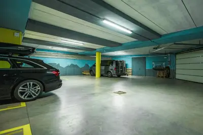 a parking garage with a car parked in it at Family-Friendly Mountain Home In The Dolomites in Campitello di Fassa
