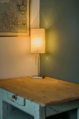 a table with a lamp on top of it at Apartment In The Dolomites With Panoramic View in Campitello di Fassa