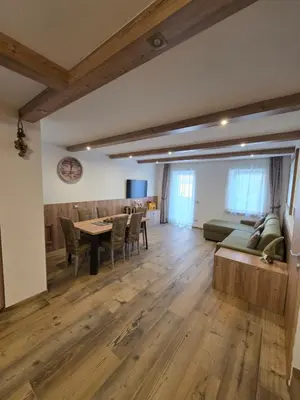 a living room with a table and a couch at Appartamento La Meridiana in Tonadico