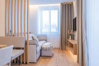 a living room with a couch and a window at Apartament Tre Cime in San Sigismondo