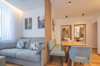a dining room with a wooden table and chairs at Appartament Lago di Braies in San Sigismondo