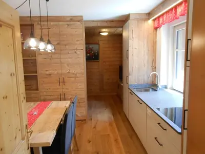 a kitchen with wooden walls and a wooden counter top at Ferienwohnung Lamprechtsburg in Brunico