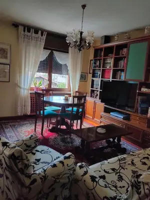 a living room with a table and a couch at La Casa di Anna in Agordo
