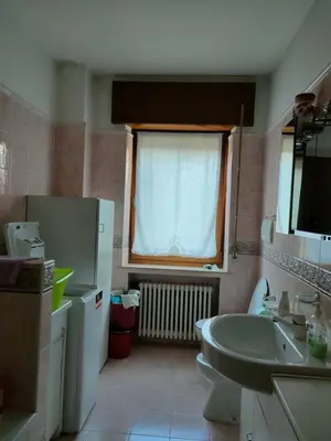 a bathroom with a sink and a tub and a window at La Casa di Anna in Agordo