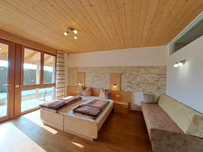 a bedroom with two beds and a couch at Apartment Sonnschein Brunnerhof in Feldthurns