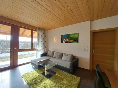 a living room with a couch and a table at Apartment Sonnschein Brunnerhof in Feldthurns