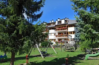 a building with a playground in a park at Paola in Santa Cristina in Val Gardena