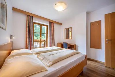 a large bed in a room with a window at Paola in Santa Cristina in Val Gardena