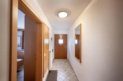 a hallway with a door and a tile floor at Paola in Santa Cristina in Val Gardena