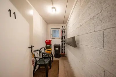 a hallway with chairs and a brick wall at Paola in Santa Cristina in Val Gardena