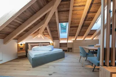 a room with a bed and a table and a bath tub at Il rifugio dei sogni - Exclusive Apartments in San Sigismondo